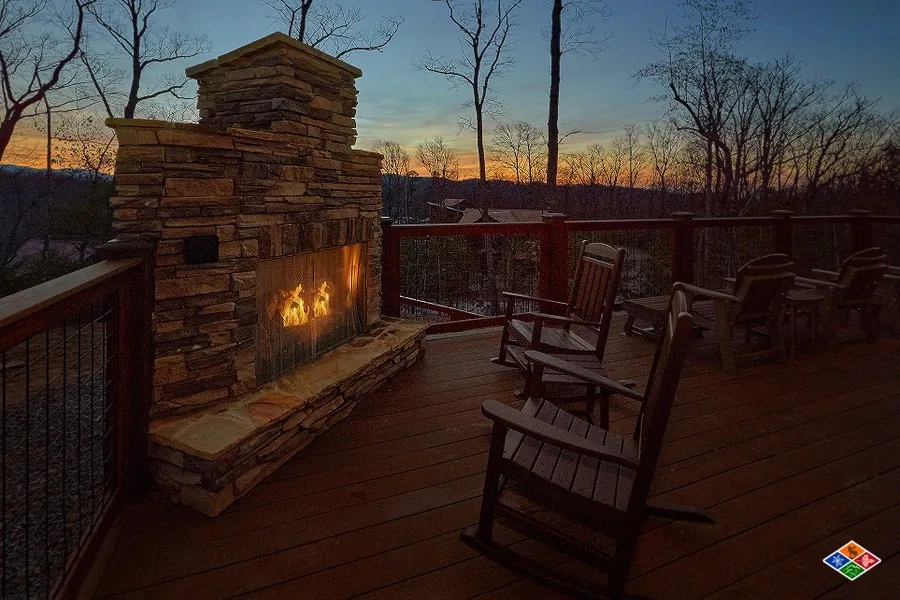 Stacked-stone outdoor fireplace on the Barrel Top Lodge deck