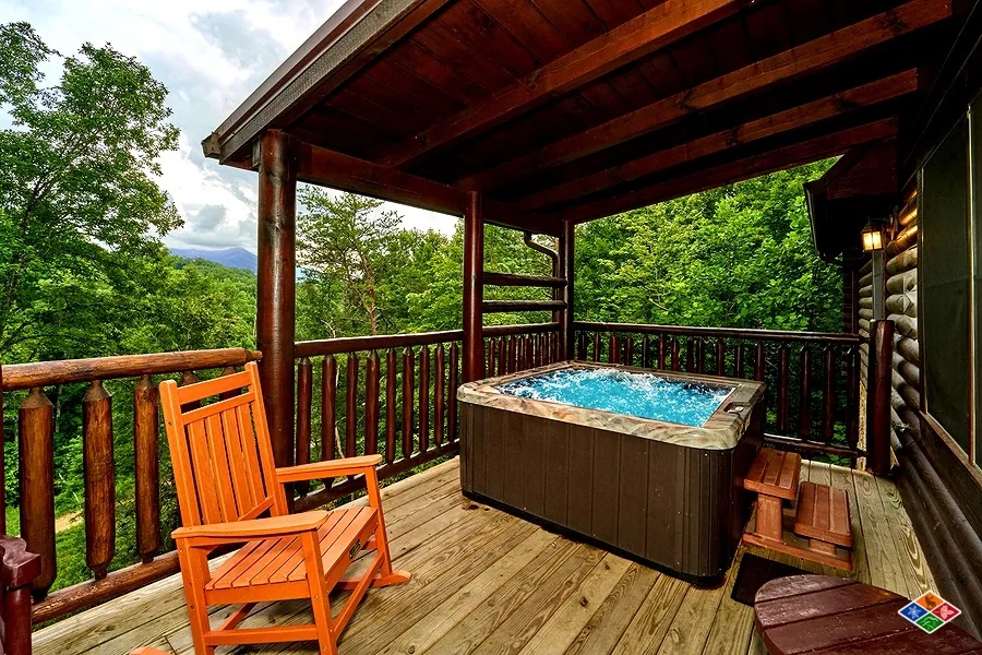 Outdoor hot tub on the covered deck at Cowboy Way with a mountain view