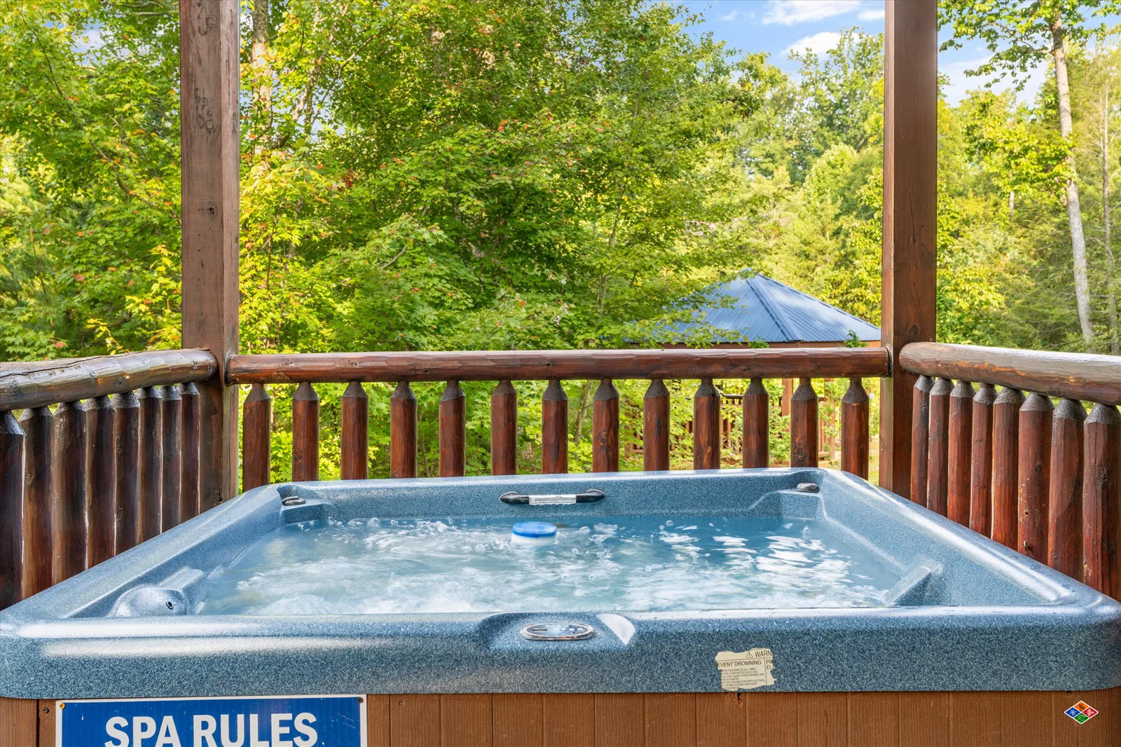 Outdoor hot tub on the covered deck at Summit Sanctuary
